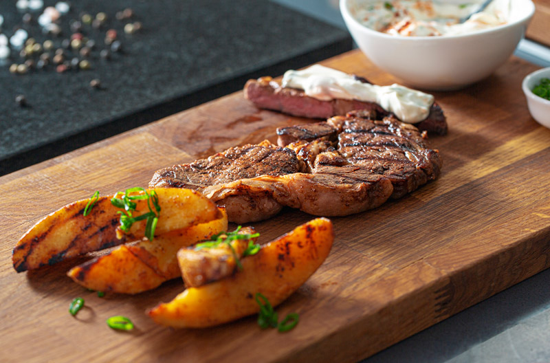 Grilled ribeye steaks and potatoes with smoky paprika rub