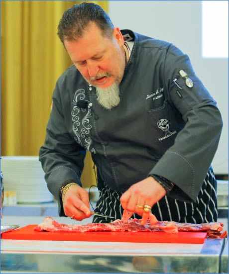 Thomas A. Gugler, president of the World Association of Chefs’ Societies, performs a U.S. beef cutting demonstration at the event in Saudi Arabia